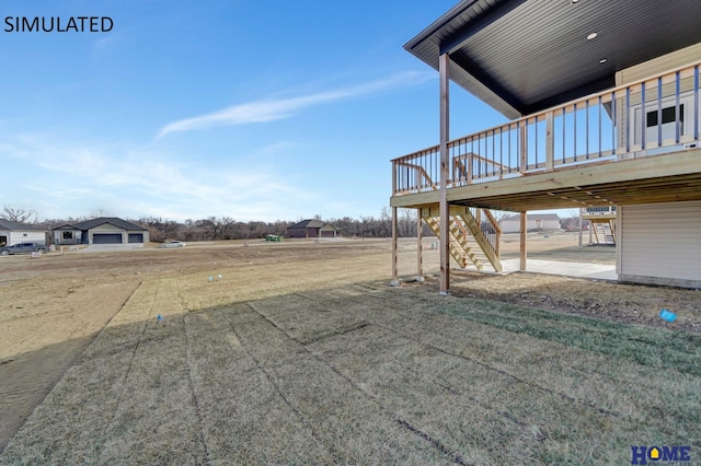 view of yard with a wooden deck and stairs