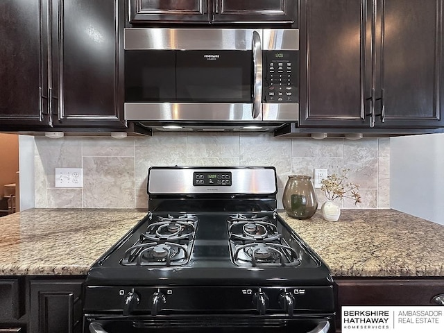 kitchen with stainless steel microwave, backsplash, black range with gas stovetop, and dark brown cabinetry