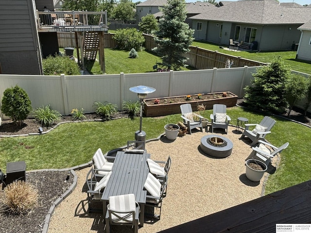 view of yard with a patio, an outdoor fire pit, a vegetable garden, a fenced backyard, and a residential view