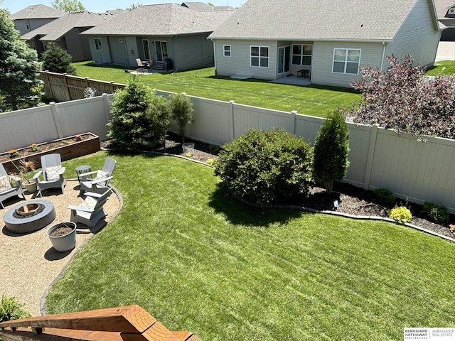 view of yard featuring a fire pit, a residential view, a fenced backyard, a garden, and a patio