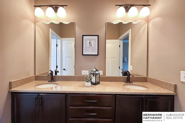 full bathroom featuring a sink and double vanity