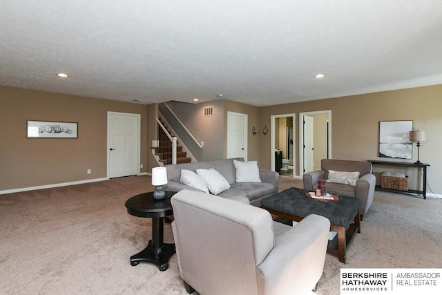 carpeted living room with stairs, visible vents, recessed lighting, and baseboards