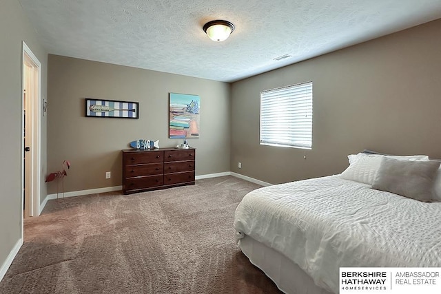 carpeted bedroom with baseboards, visible vents, and a textured ceiling