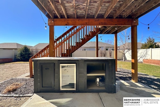 view of patio / terrace featuring stairs and a fenced backyard