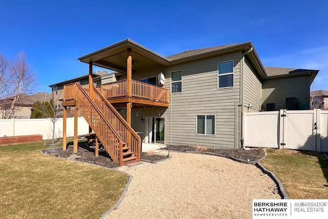 back of property featuring a wooden deck, fence, stairs, and a gate