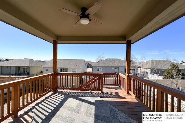 deck featuring a residential view and ceiling fan