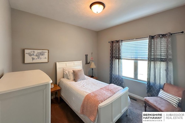 bedroom with baseboards and visible vents