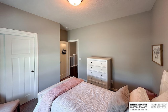 bedroom featuring a textured ceiling and baseboards