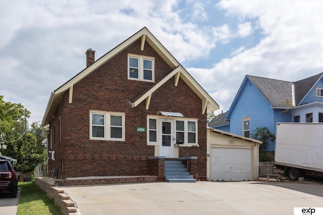 view of front of house featuring concrete driveway, a garage, brick siding, and a chimney