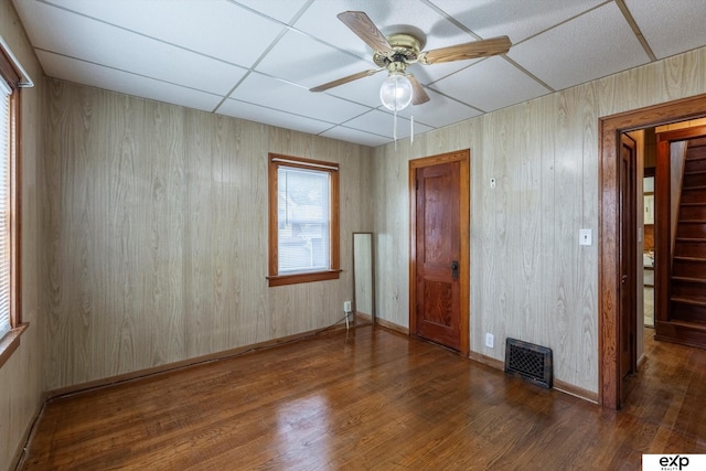 unfurnished room featuring visible vents, baseboards, a ceiling fan, and wood finished floors