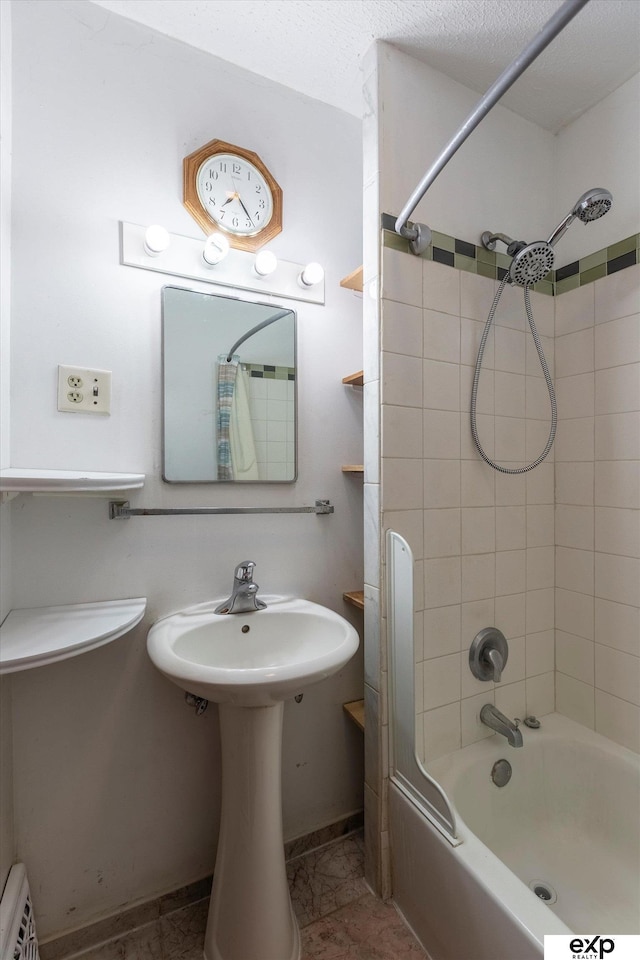 full bathroom featuring a baseboard heating unit and shower / tub combo with curtain