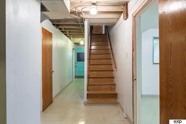 stairs featuring tile patterned floors and baseboards