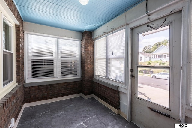 unfurnished sunroom featuring a wealth of natural light