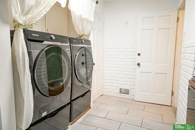 laundry room featuring visible vents, washing machine and dryer, and laundry area