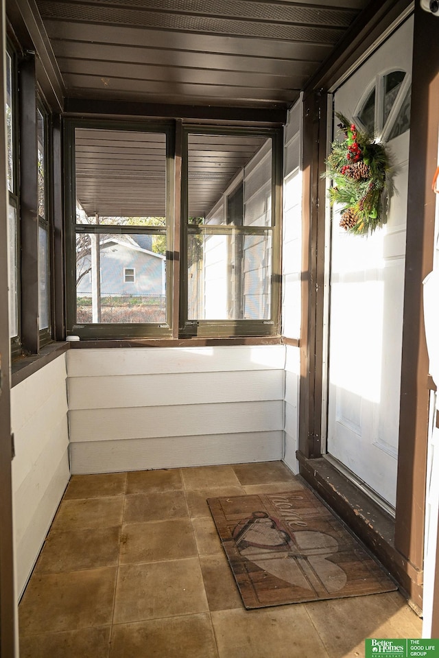 unfurnished sunroom featuring wooden ceiling