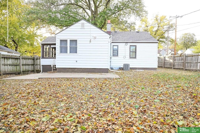 rear view of house with a patio area, a fenced backyard, and roof with shingles