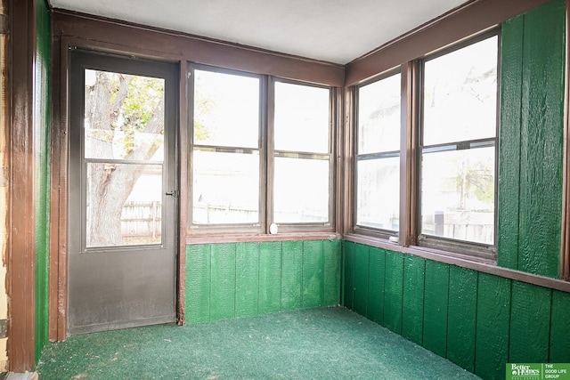 unfurnished sunroom featuring a wealth of natural light