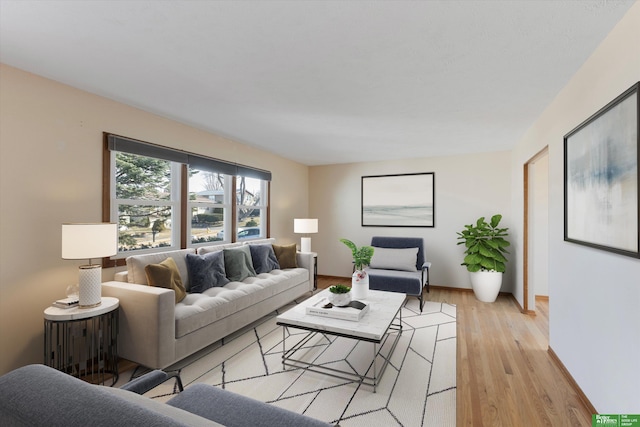 living room featuring baseboards and light wood finished floors