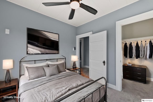 bedroom with a ceiling fan, baseboards, and carpet floors