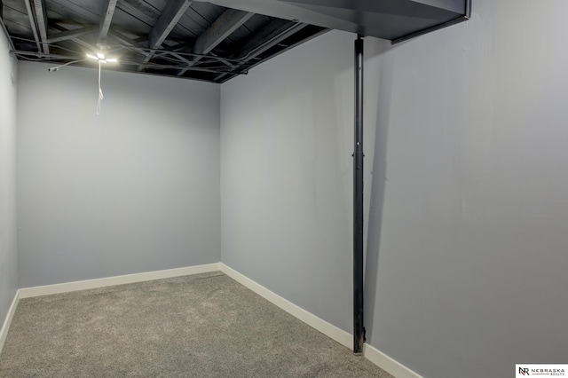 finished basement featuring baseboards and carpet