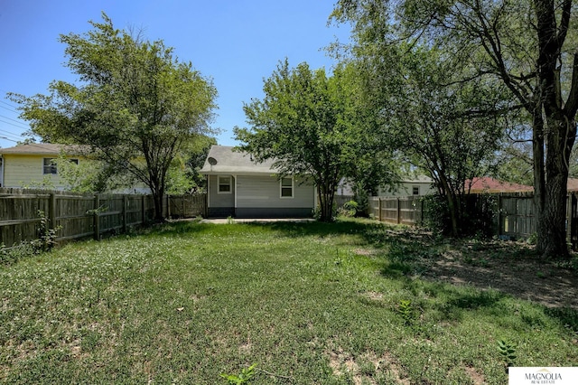 view of yard with a fenced backyard