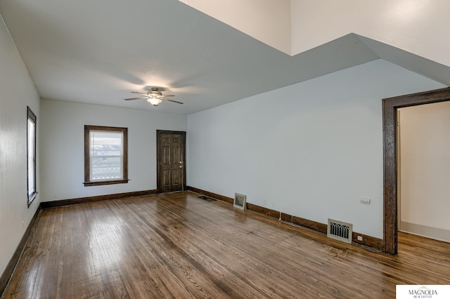 spare room featuring ceiling fan, wood finished floors, visible vents, and baseboards