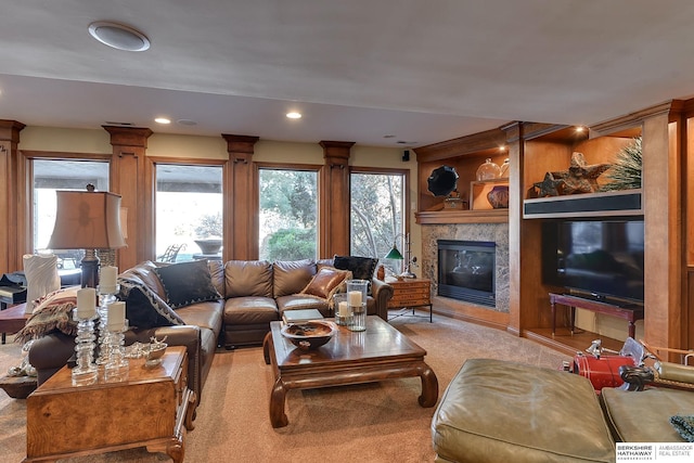 living area featuring recessed lighting, carpet, and a fireplace