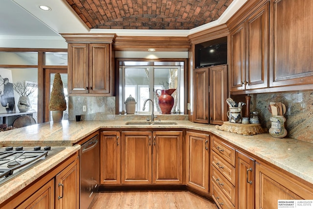 kitchen featuring brick ceiling, light stone countertops, ornamental molding, brown cabinets, and a sink