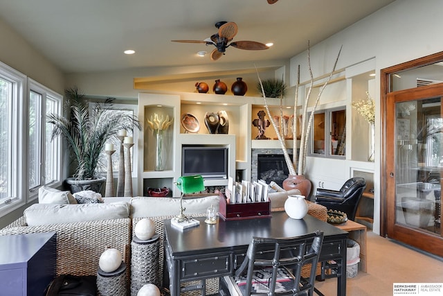 living area featuring carpet flooring, visible vents, a fireplace, and lofted ceiling