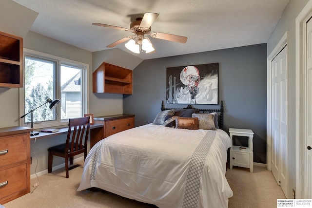 bedroom featuring light colored carpet, baseboards, and ceiling fan