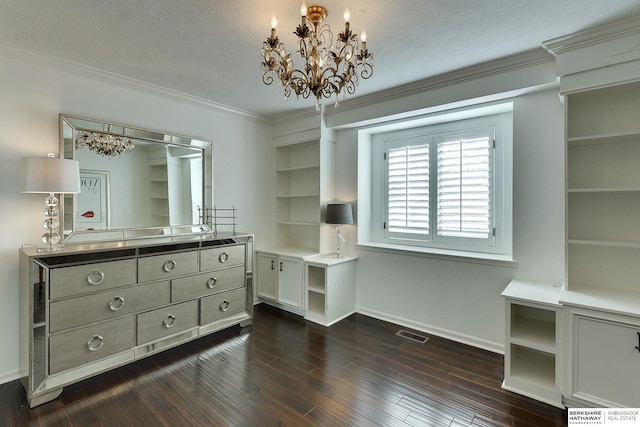 spacious closet featuring visible vents, dark wood finished floors, and a chandelier