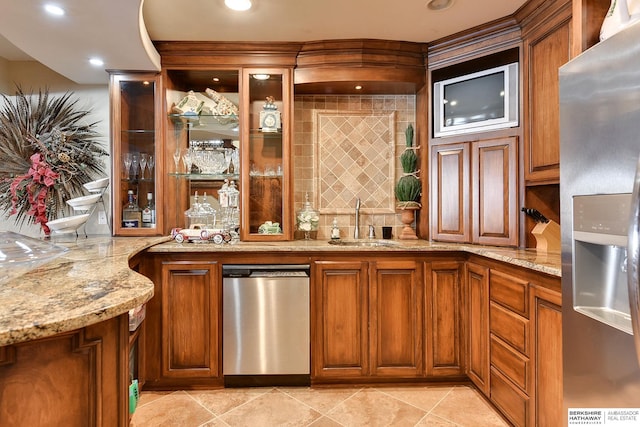 bar with wet bar, recessed lighting, stainless steel fridge with ice dispenser, and a sink