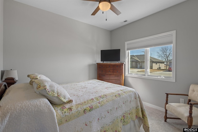 bedroom with visible vents, baseboards, carpet, and a ceiling fan