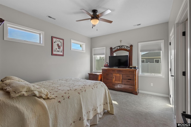 bedroom with visible vents, light carpet, baseboards, and a ceiling fan