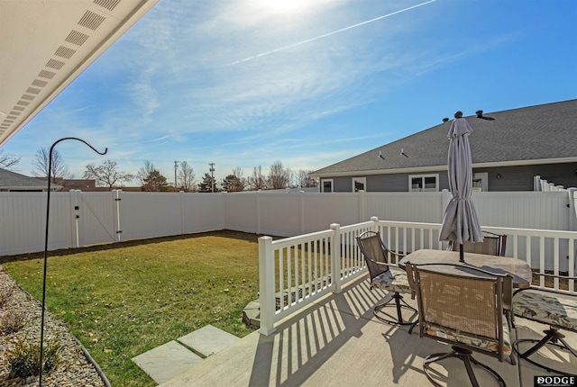 view of patio / terrace with a fenced backyard, outdoor dining space, and a gate