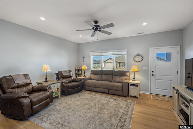 living room with visible vents, baseboards, ceiling fan, recessed lighting, and light wood-style floors