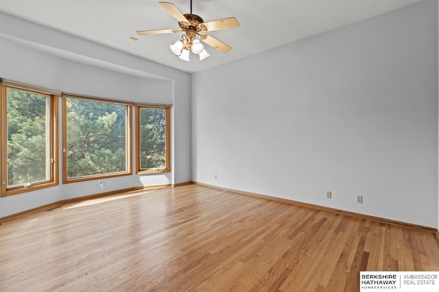 empty room featuring light wood-style flooring, baseboards, and ceiling fan