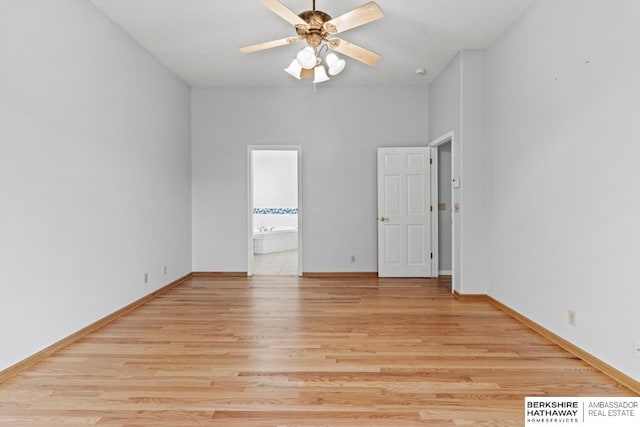 spare room with ceiling fan, baseboards, and light wood-style floors