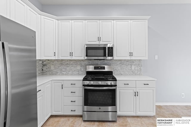 kitchen featuring stainless steel appliances, white cabinetry, backsplash, and light countertops