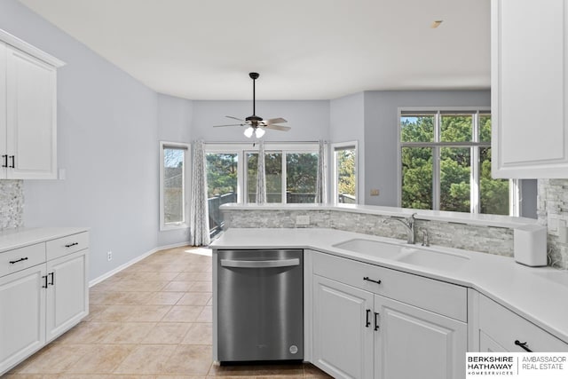 kitchen with light countertops, light tile patterned floors, decorative backsplash, stainless steel dishwasher, and a sink