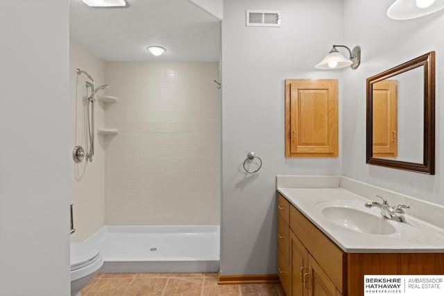 full bathroom featuring visible vents, toilet, tile patterned flooring, tiled shower, and vanity