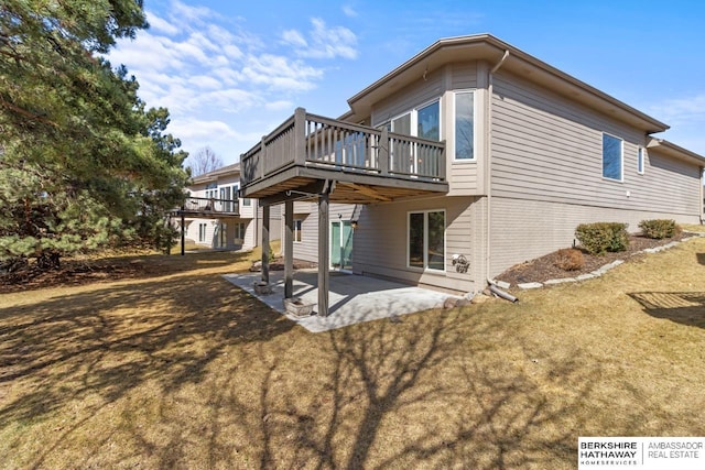 rear view of house featuring brick siding, a lawn, and a patio area