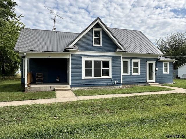 bungalow-style house with metal roof, a porch, and a front yard