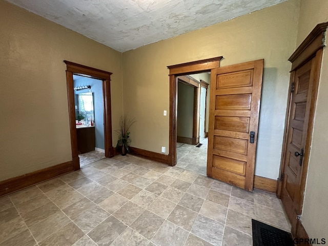 spare room with visible vents and baseboards