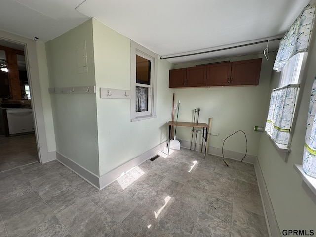 kitchen with a wealth of natural light, dishwashing machine, and baseboards