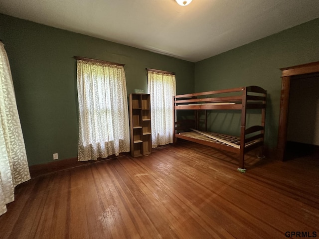 unfurnished bedroom with hardwood / wood-style floors