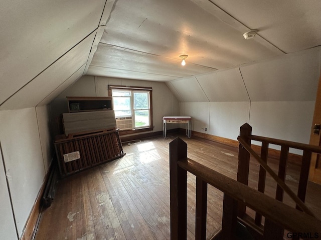 additional living space with vaulted ceiling, baseboards, and hardwood / wood-style floors