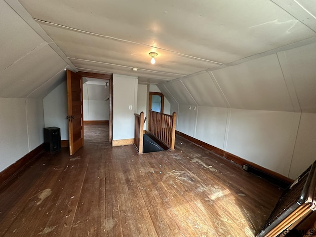 additional living space with vaulted ceiling and hardwood / wood-style flooring