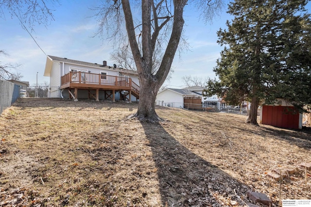 view of yard with stairs, a fenced backyard, and a wooden deck