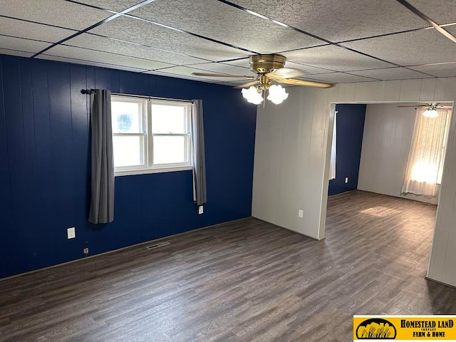 spare room with visible vents, a paneled ceiling, wood finished floors, and a ceiling fan